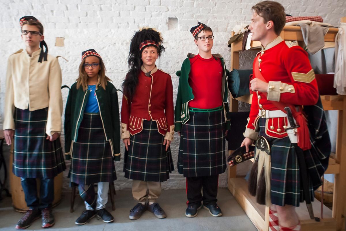 Students in Scottish garb with a tour guide